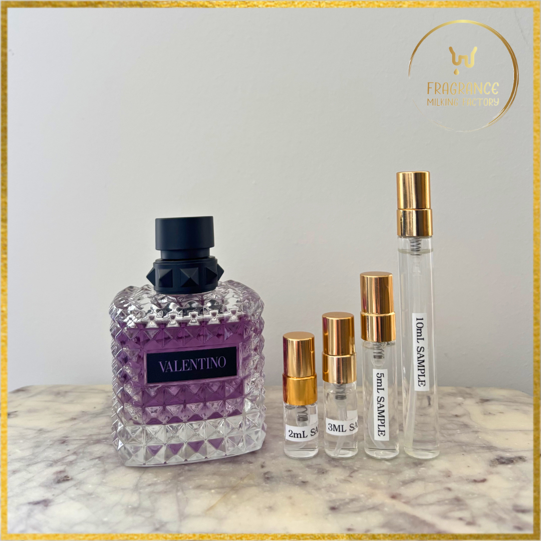 Valentino perfume bottle and smaller sample bottles on a marble surface with a neutral background.